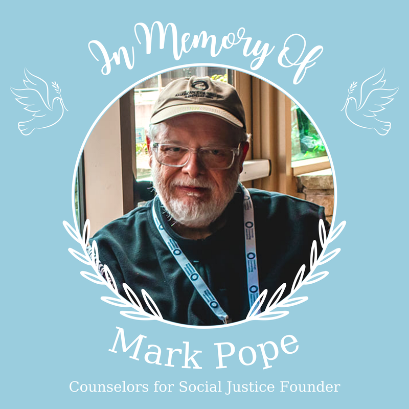 Background color: light blue Photo of Mark Pope with a white beard, wearing a tan hat and dark green shirt, surrounded by a white border with leaves Text says : In memory of Mark Pope Counselors for Social Justice Founder Two white outlines of doves holding a plant facing the photoPicture